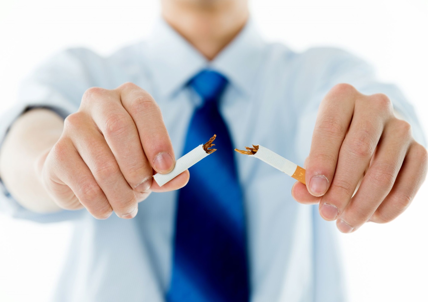 A close-up of a person breaking a cigaretteDescription